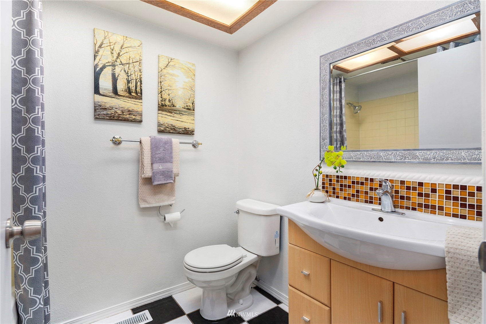 4800 South Frontenac Street Seattle, WA 98118 - Photo 22 of 40 a bathroom with a sink a toilet and mirror