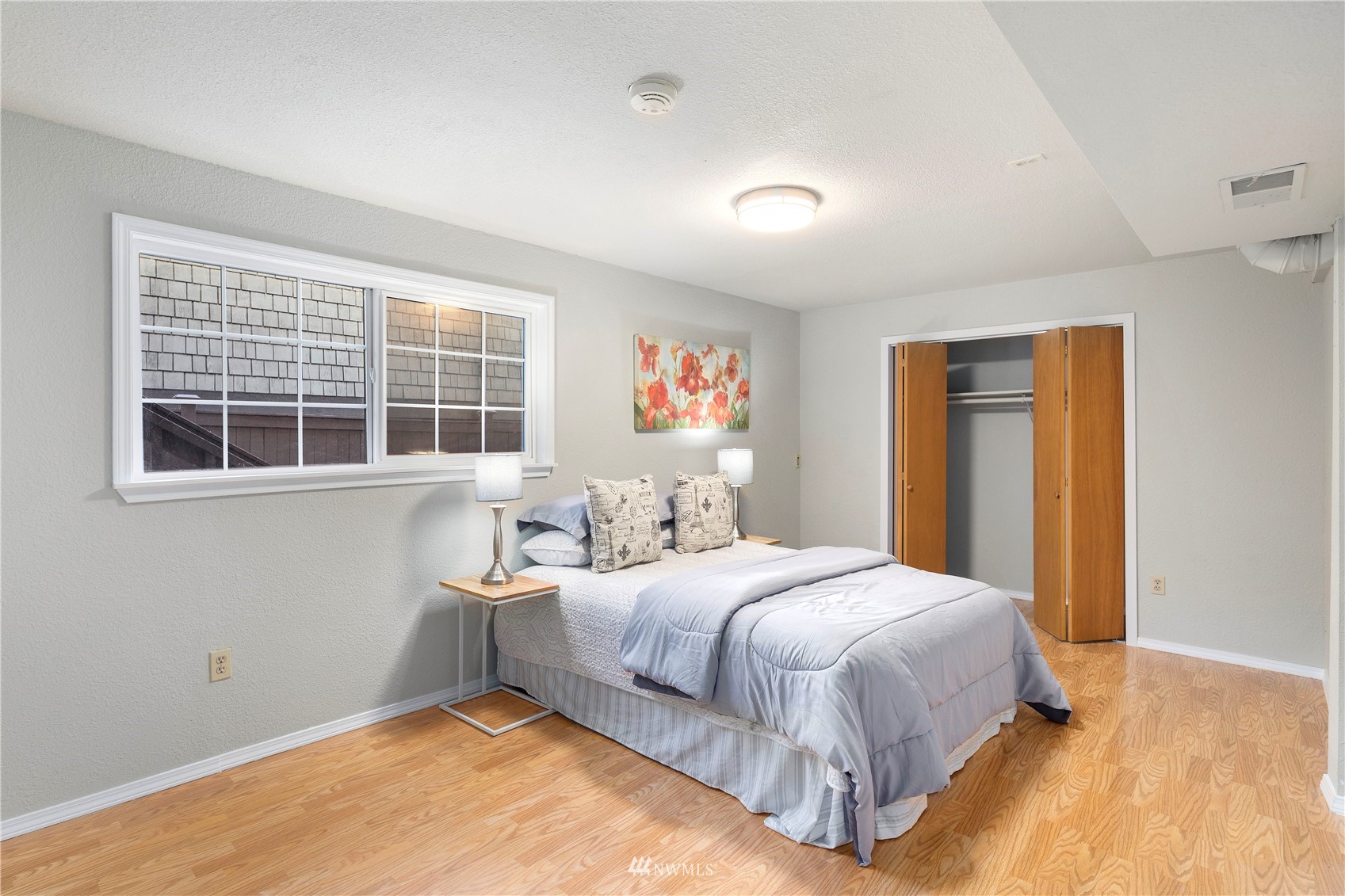4800 South Frontenac Street Seattle, WA 98118 - Photo 26 of 40 a bedroom with a bed and window