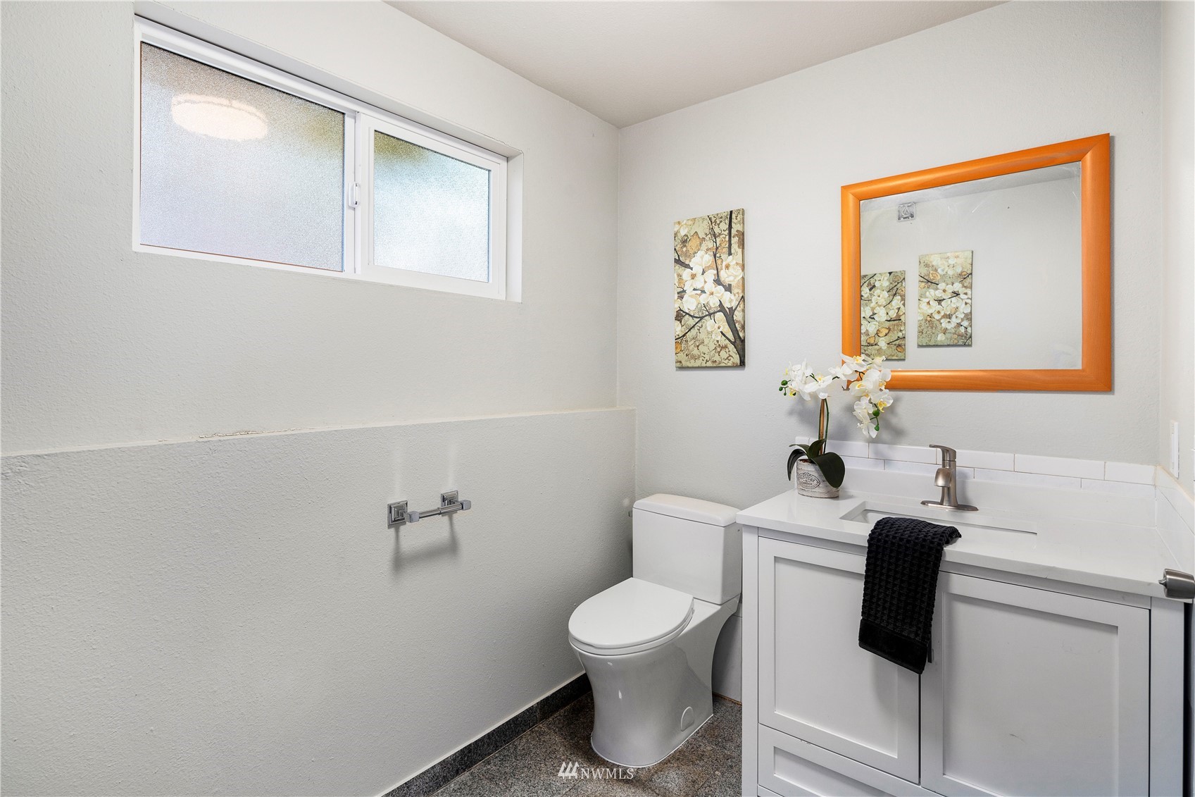 4800 South Frontenac Street Seattle, WA 98118 - Photo 28 of 40 a bathroom with a toilet a sink and mirror