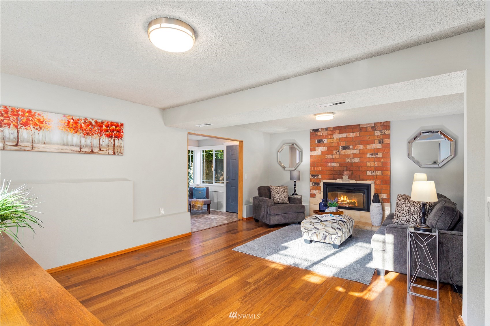 4800 South Frontenac Street Seattle, WA 98118 - Photo 31 of 40 a living room with furniture a fireplace and a flat screen tv