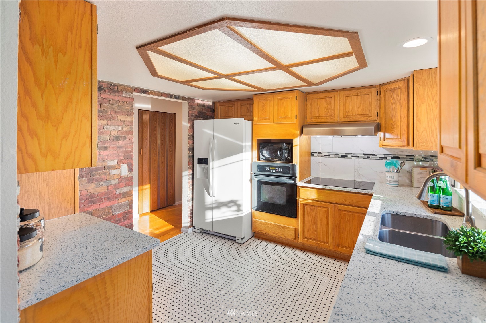 4800 South Frontenac Street Seattle, WA 98118 - Photo 10 of 40 a kitchen with stainless steel appliances granite countertop a sink a stove and a refrigerator