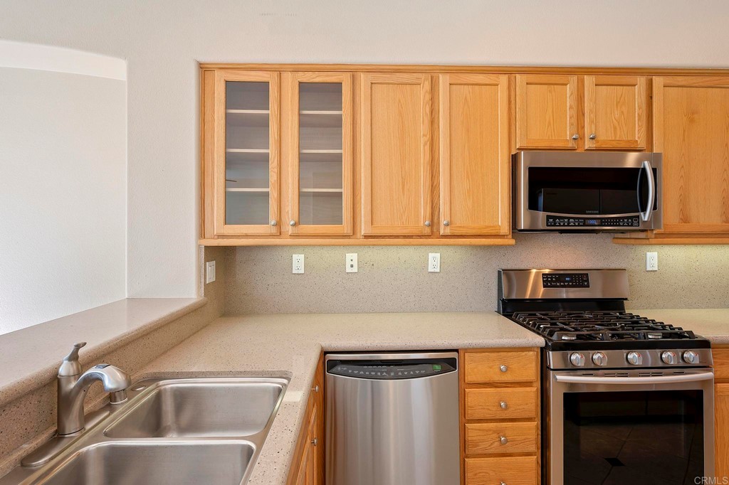 1295 Highbluff Avenue San Marcos, CA 92078 - Photo 14 of 38 a kitchen with a sink a stove and microwave