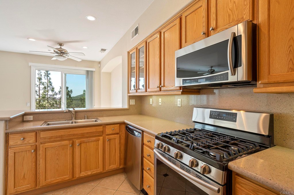 1295 Highbluff Avenue San Marcos, CA 92078 - Photo 17 of 38 a kitchen with cabinets appliances and a sink