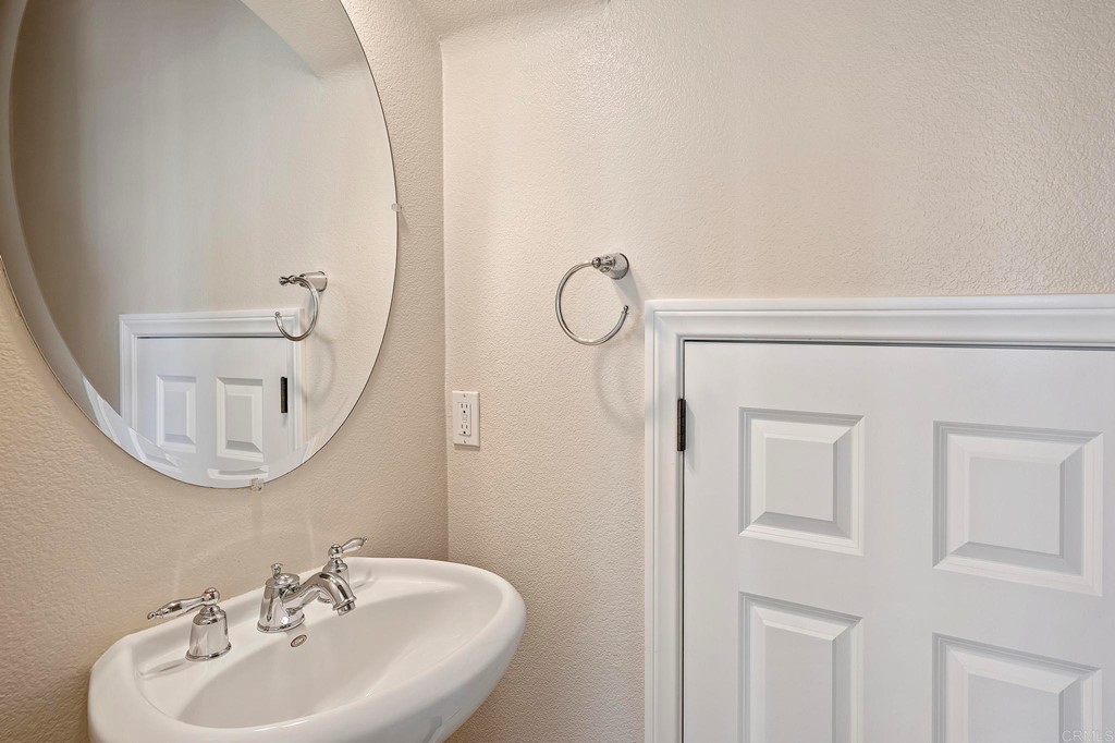 1295 Highbluff Avenue San Marcos, CA 92078 - Photo 18 of 38 a bathroom with a sink a mirror and vanity
