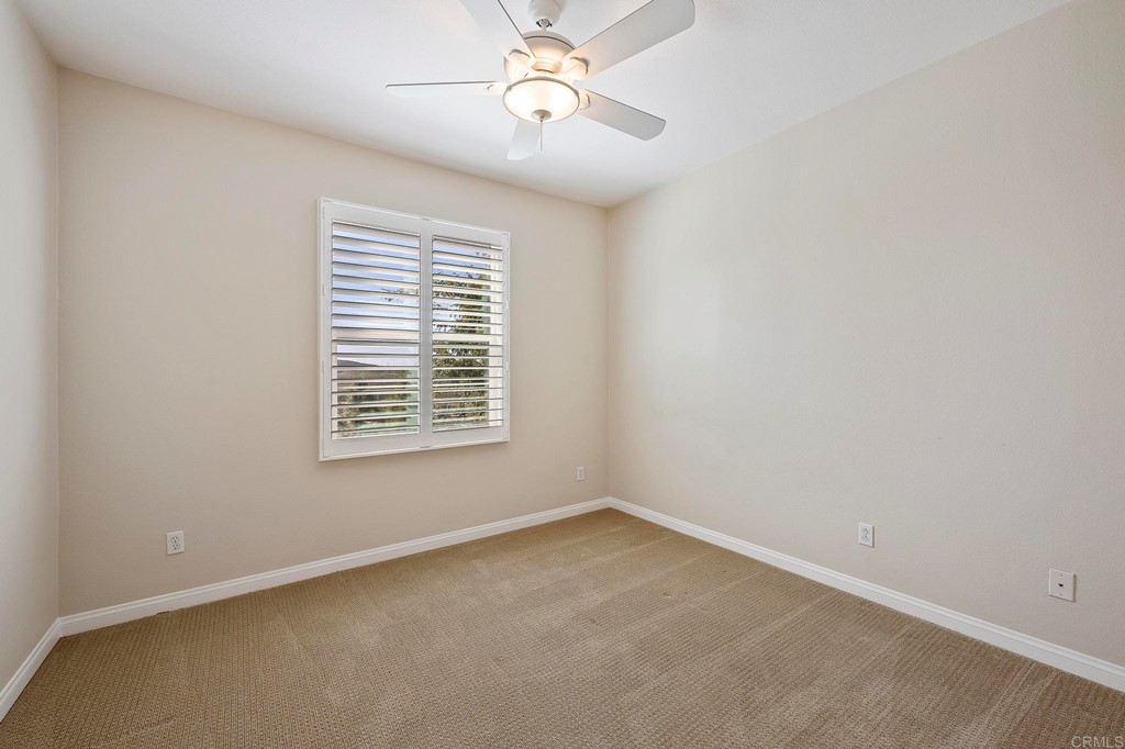 1295 Highbluff Avenue San Marcos, CA 92078 - Photo 19 of 38 an empty room with a window and a fan