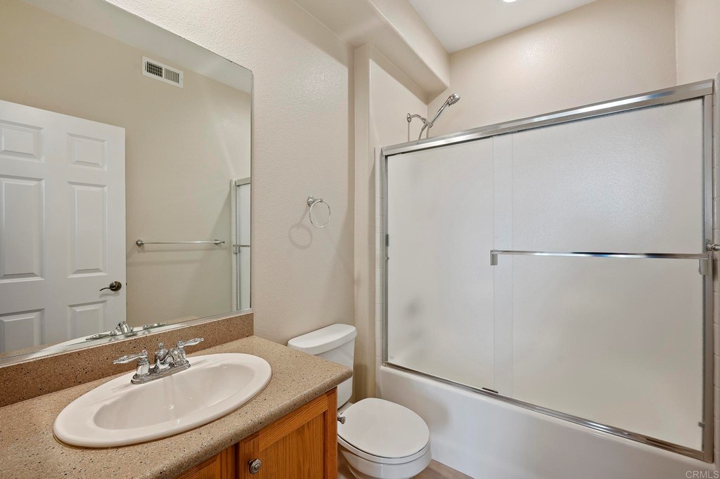 1295 Highbluff Avenue San Marcos, CA 92078 - Photo 21 of 38 a bathroom with a sink toilet and shower