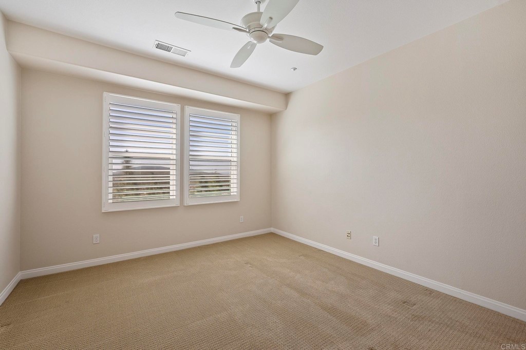 1295 Highbluff Avenue San Marcos, CA 92078 - Photo 23 of 38 an empty room with a window and a ceiling fan