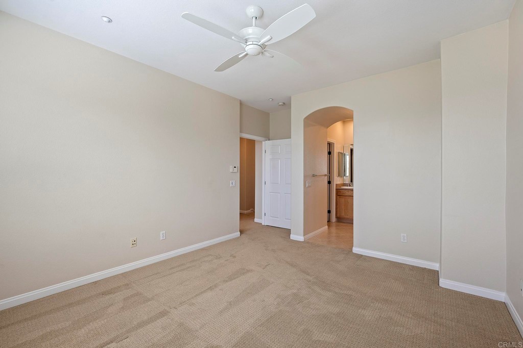 1295 Highbluff Avenue San Marcos, CA 92078 - Photo 24 of 38 an empty room with closet and a chandelier fan