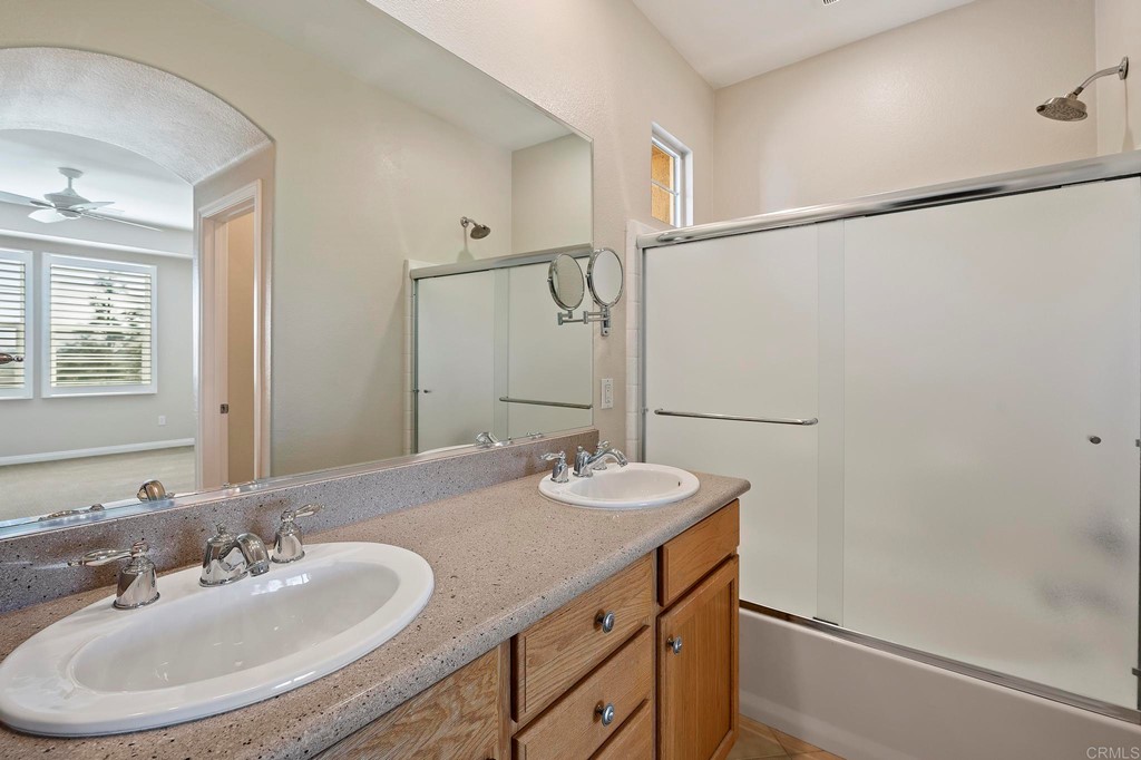 1295 Highbluff Avenue San Marcos, CA 92078 - Photo 25 of 38 a bathroom with a sink and a mirror
