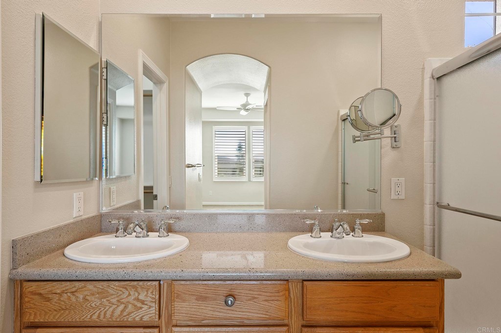 1295 Highbluff Avenue San Marcos, CA 92078 - Photo 26 of 38 a bathroom with double vanity sinks and a mirror