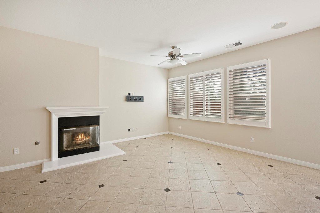 1295 Highbluff Avenue San Marcos, CA 92078 - Photo 7 of 38 a view of an empty room with a fireplace and a window