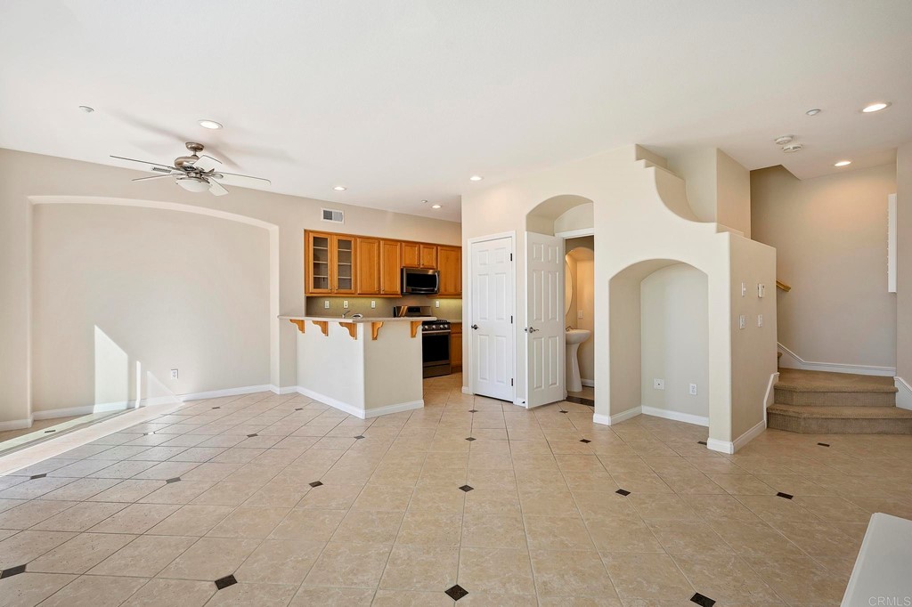 1295 Highbluff Avenue San Marcos, CA 92078 - Photo 9 of 38 a view of kitchen with refrigerator stove and wooden cabinets
