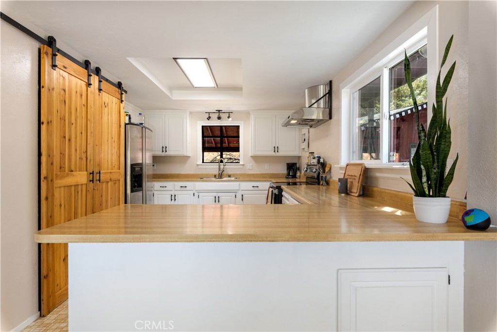 2225 Ladder Ridge Road Upper Lake, CA 95485 - Photo 13 of 58 a kitchen with sink refrigerator and window