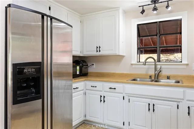 a kitchen with a refrigerator and a sink
