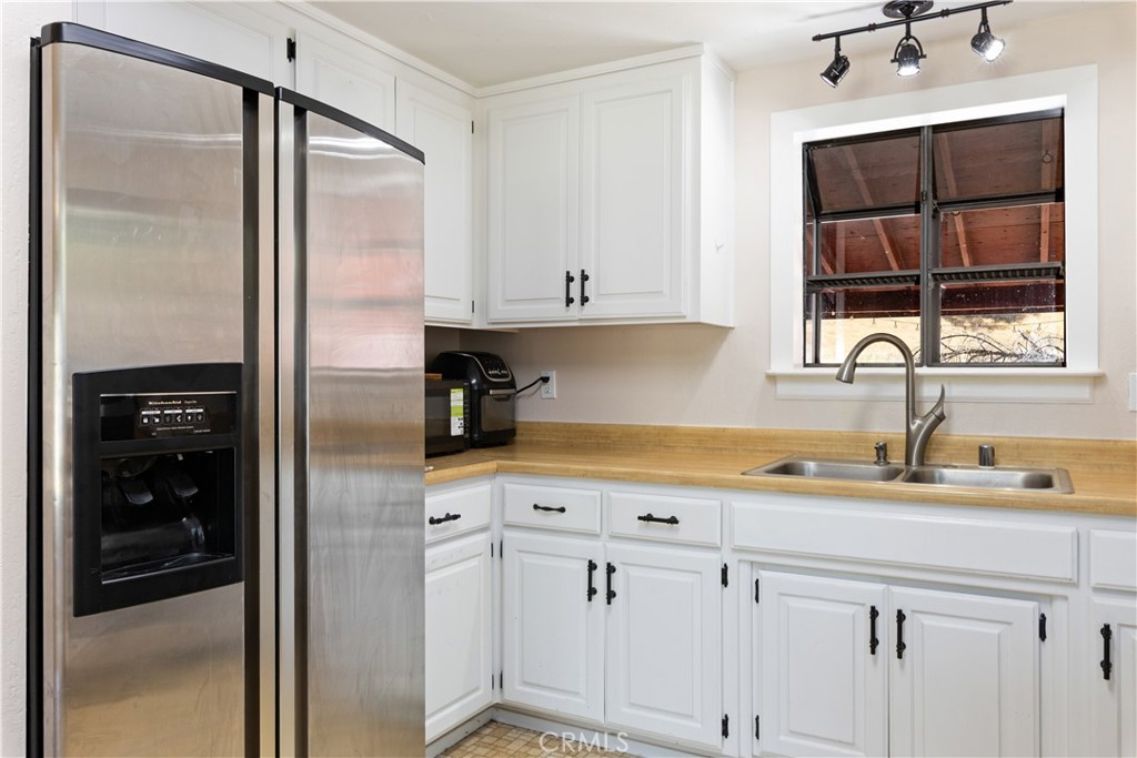 2225 Ladder Ridge Road Upper Lake, CA 95485 - Photo 15 of 58 a kitchen with a refrigerator and a sink