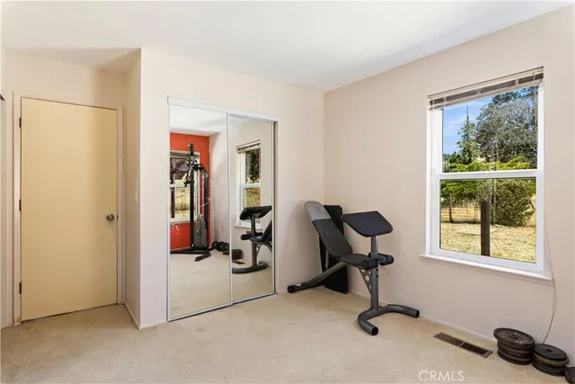 a view of a hallway with wooden floor and entryway