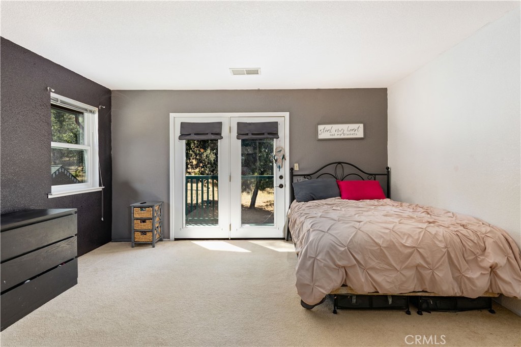 2225 Ladder Ridge Road Upper Lake, CA 95485 - Photo 23 of 58 a bedroom with a bed and a dresser next to a window