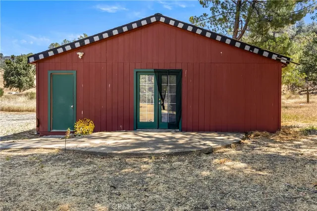 a bedroom with a bed and dresser with mirror