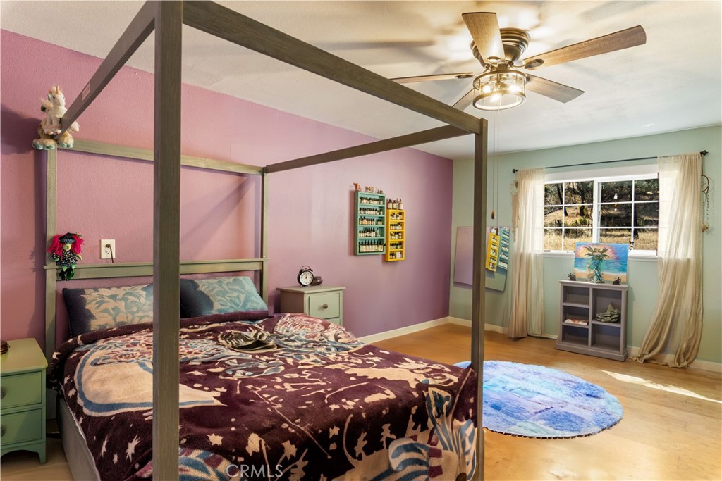 2225 Ladder Ridge Road Upper Lake, CA 95485 - Photo 34 of 58 a bedroom with a bed and dresser with mirror