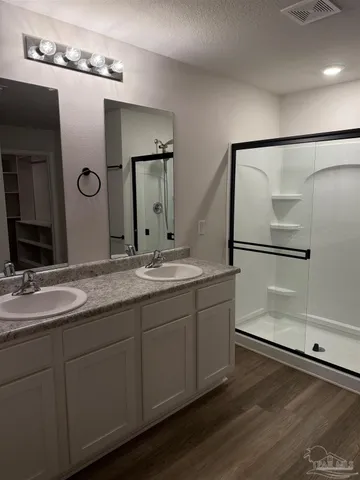 a bathroom with a double vanity sink and a mirror