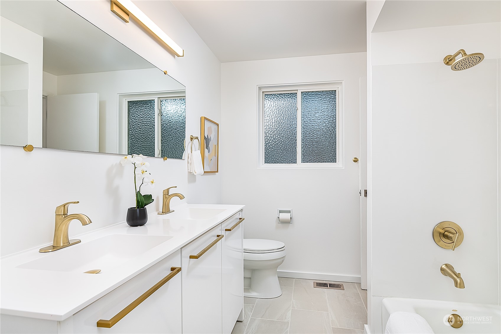 5 234th Place Southeast Bothell, WA 98021 - Photo 9 of 22 a bathroom with a sink a toilet and shower curtain