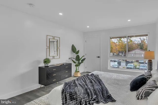 a bedroom with a bed and window