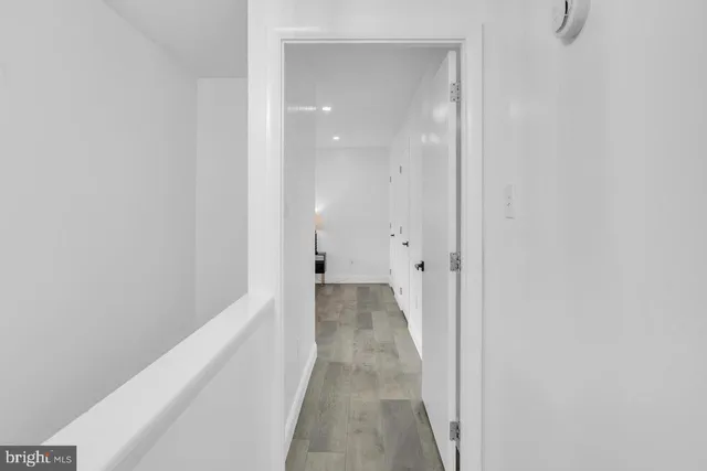 a view of a hallway with wooden floor