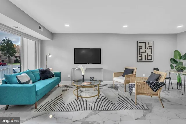a living room with furniture and a flat screen tv