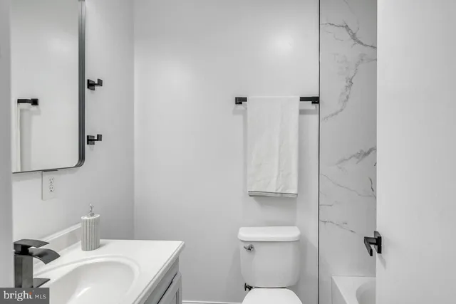 a bathroom with a sink toilet and vanity