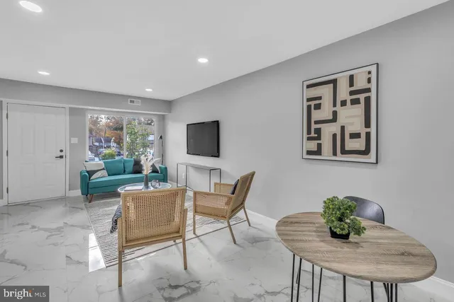 a living room with furniture and a table