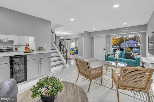 a living room with furniture and flowers