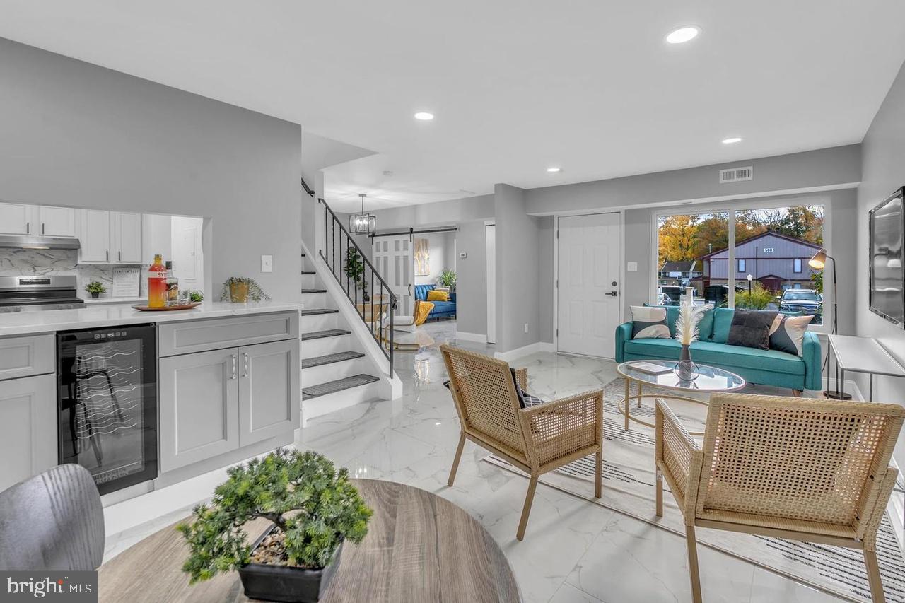 201 Timber Creek Road Lindenwold, NJ 08021 - Photo 26 of 38 a living room with furniture and flowers