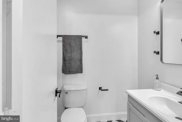 a bathroom with a sink toilet and vanity