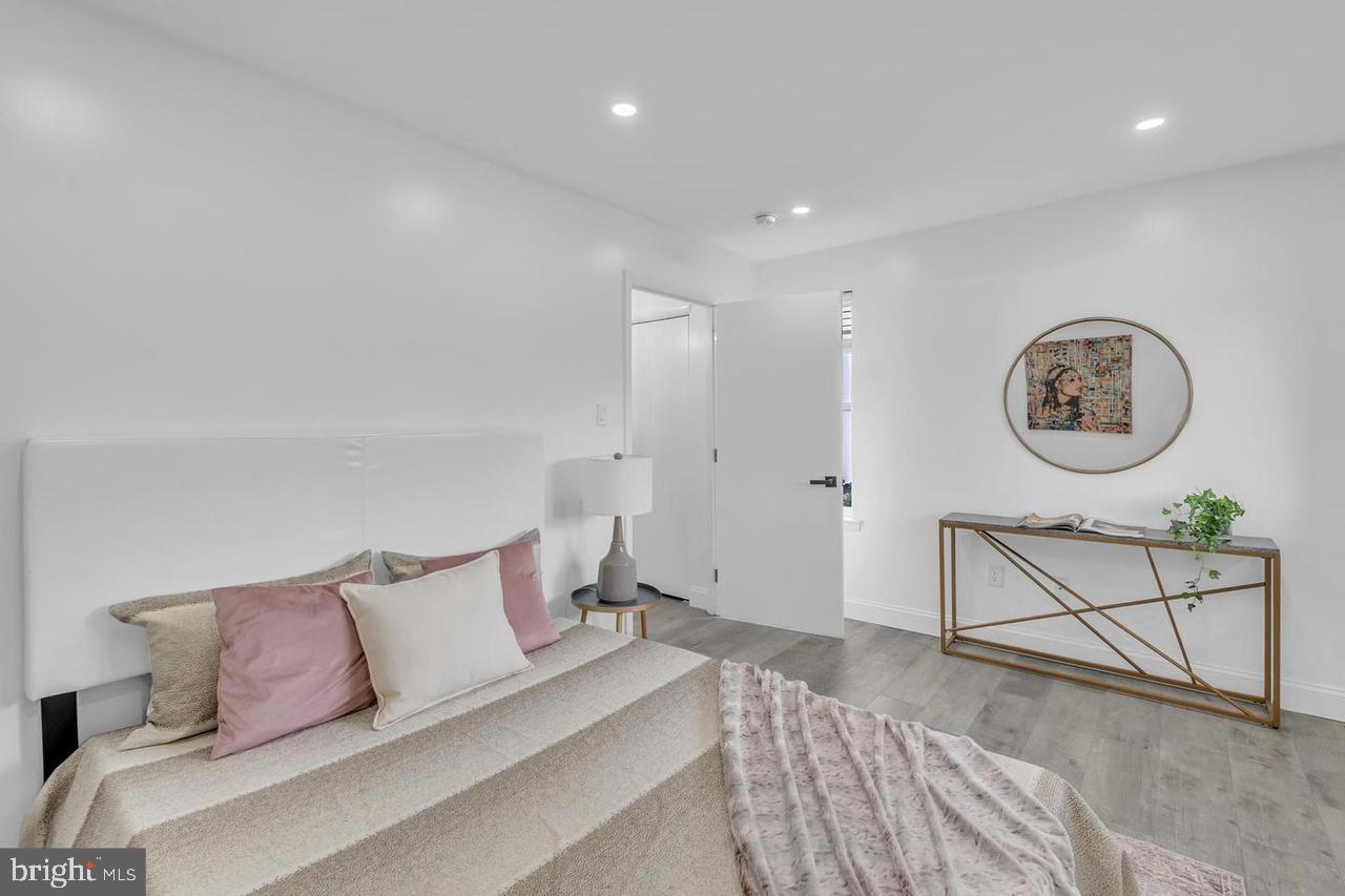 201 Timber Creek Road Lindenwold, NJ 08021 - Photo 37 of 38 a spacious bedroom with a bed a couch and a lamp on table