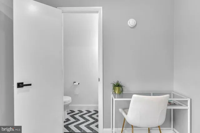 a view of a room with a potted plant on a table and chair