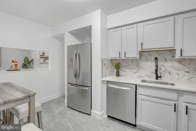 a kitchen with appliances cabinets and a sink