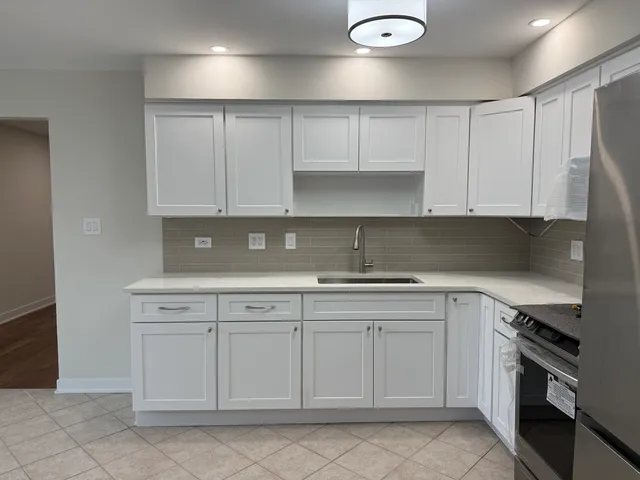 a kitchen with white cabinets