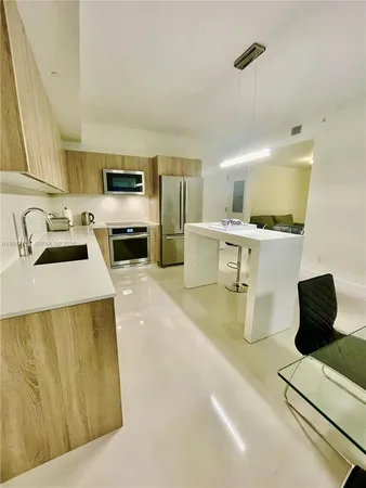 a kitchen with a sink a stove and cabinets