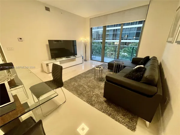 a living room with furniture and a flat screen tv