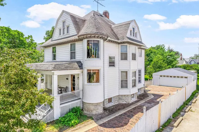 a front view of a house with sitting area
