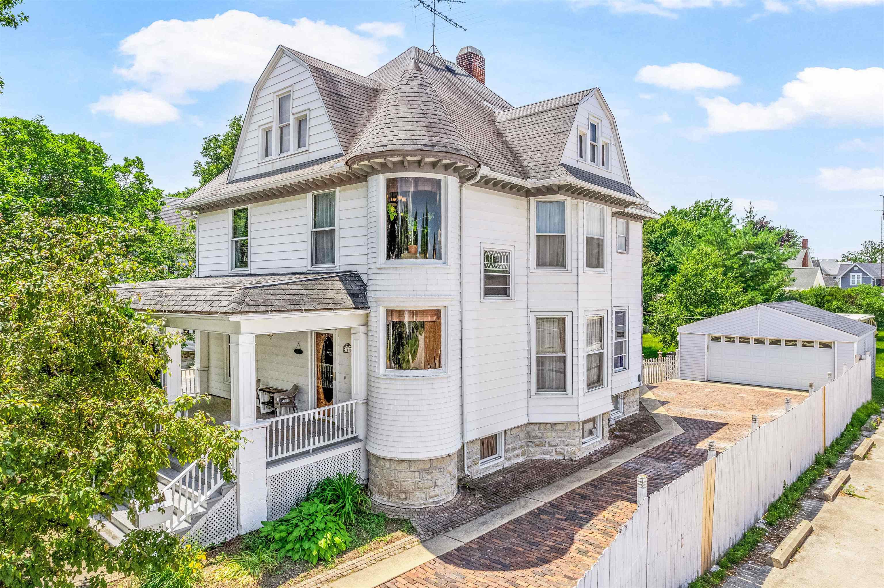a front view of a house with sitting area