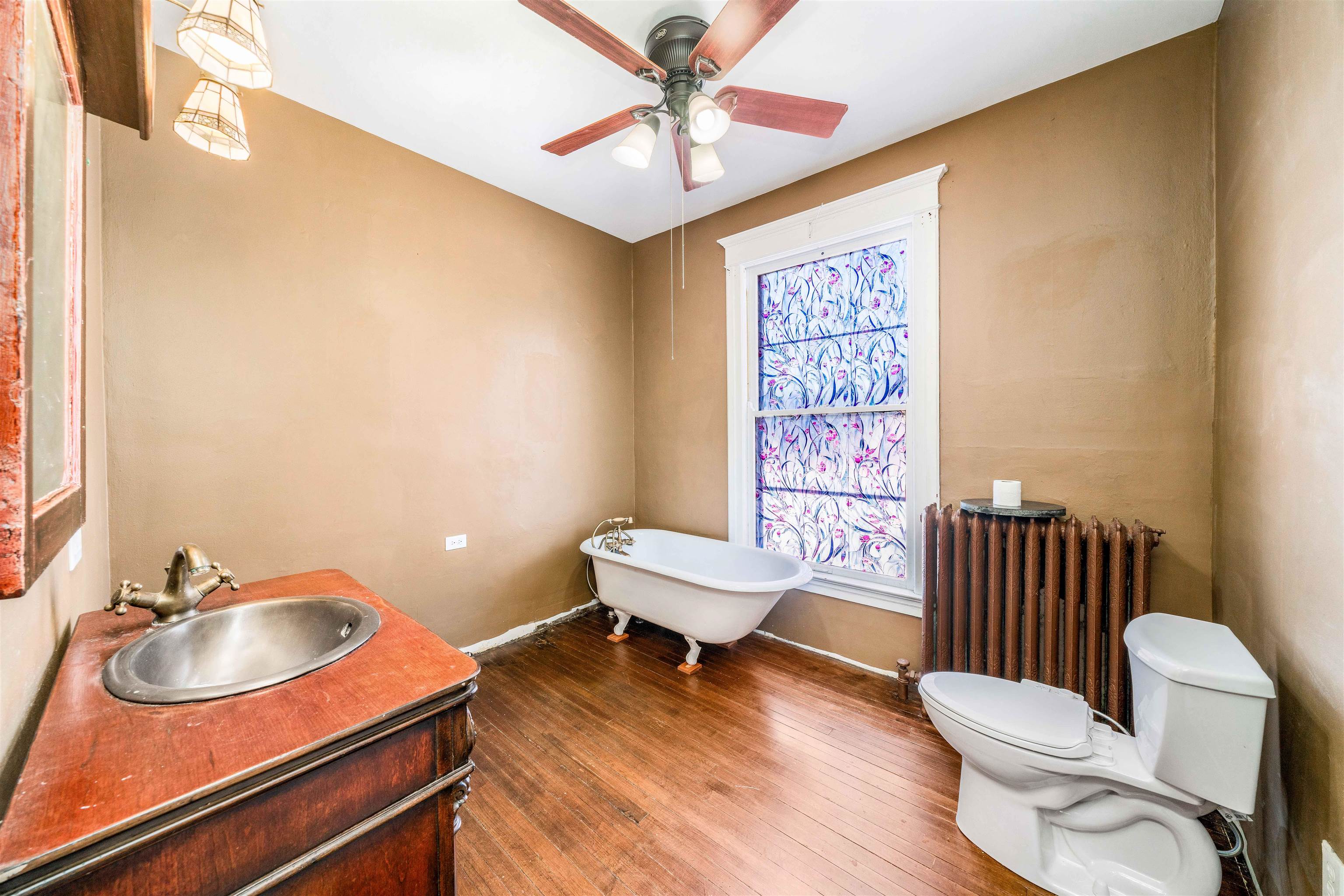111 South Sycamore Street Genoa, IL 60135 - Photo 13 of 22 a bathroom with a sink a toilet and a mirror