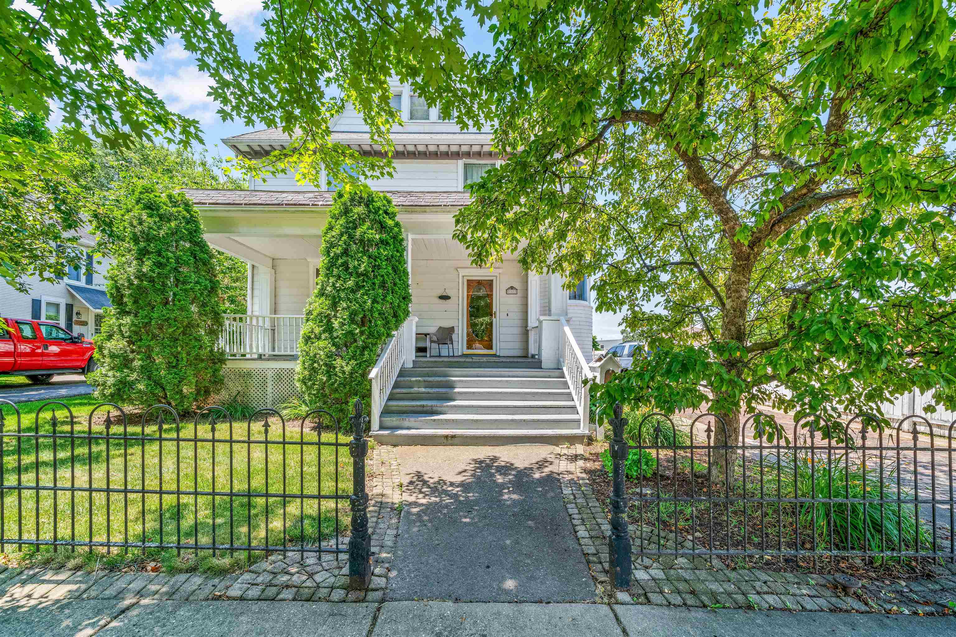 111 South Sycamore Street Genoa, IL 60135 - Photo 14 of 22 a front view of a house with a garden