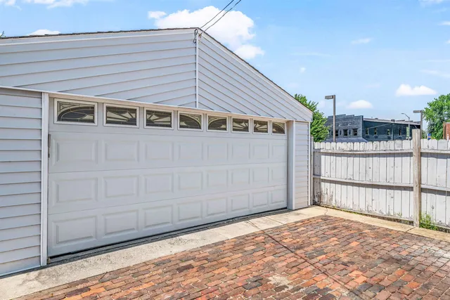 a view of a house with a wooden fence