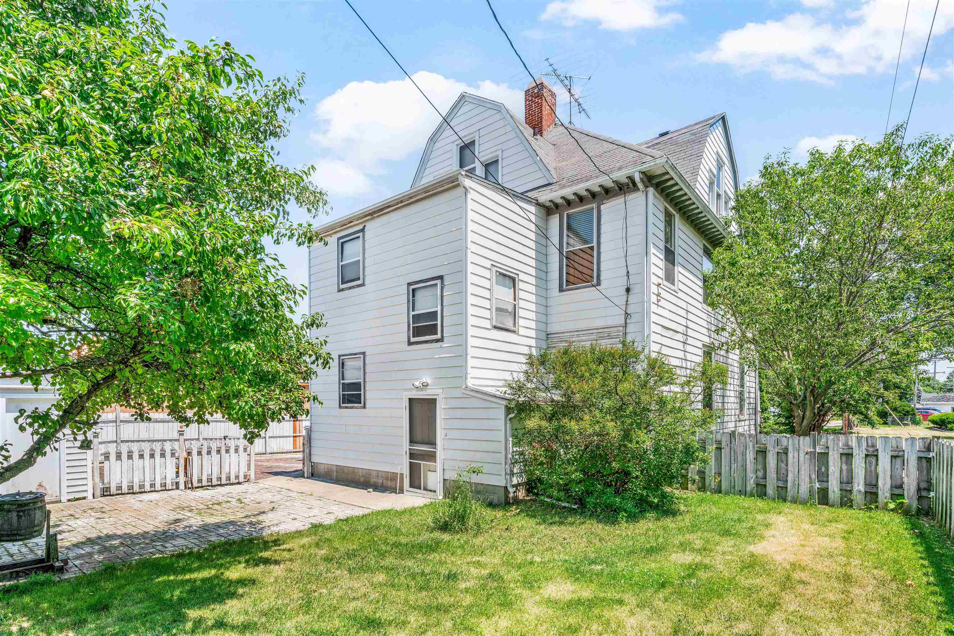 111 South Sycamore Street Genoa, IL 60135 - Photo 17 of 22 a front view of a house with a garden