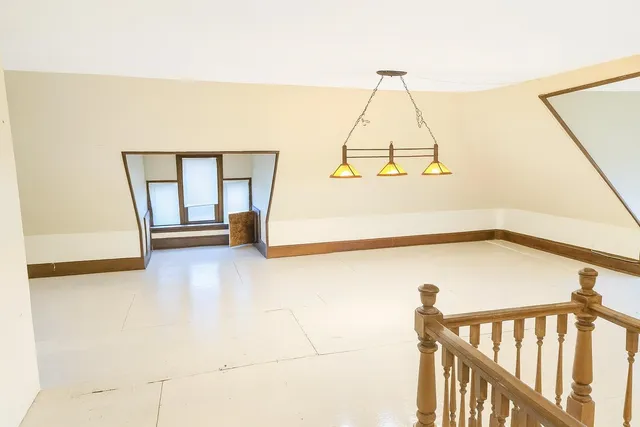 a view of a room with wooden floor and windows