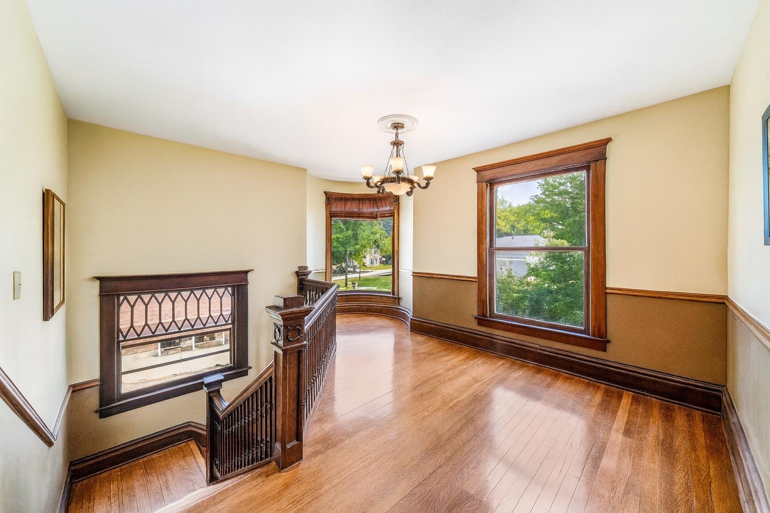 111 South Sycamore Street Genoa, IL 60135 - Photo 22 of 22 a view of an empty room with a window and wooden floor