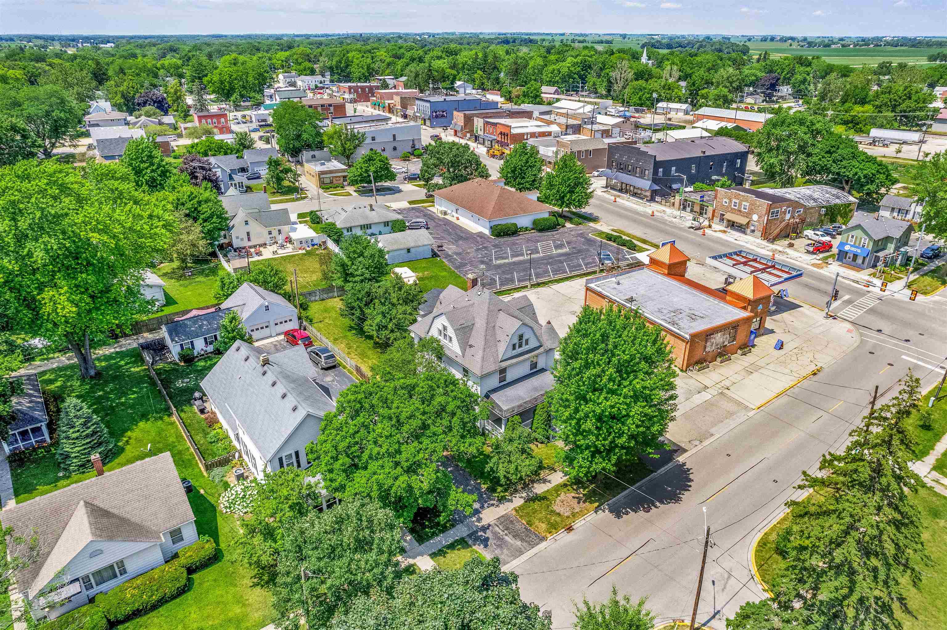 111 South Sycamore Street Genoa, IL 60135 - Photo 4 of 22 an aerial view of a city with lots of residential buildings ocean and mountain view in back