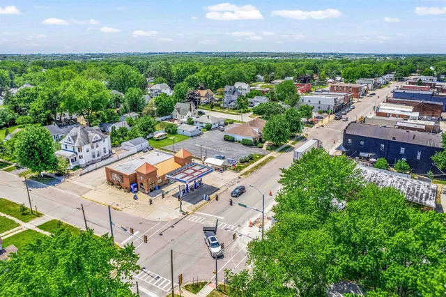 an aerial view of a house with a garden and trees