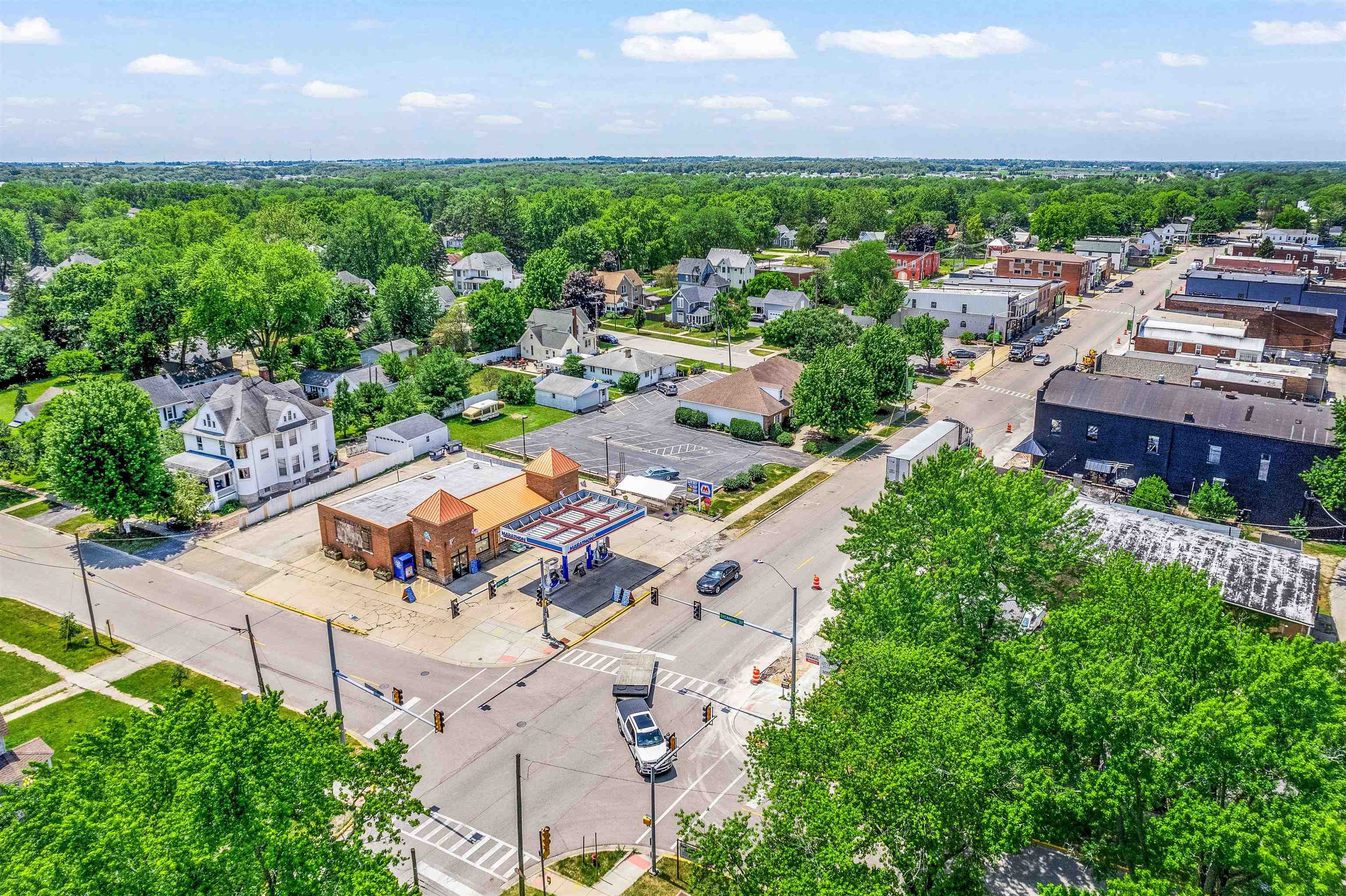 111 South Sycamore Street Genoa, IL 60135 - Photo 5 of 22 an aerial view of a house with a garden and trees